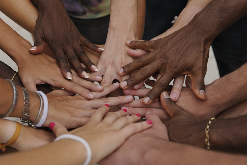People's hands displaying different races