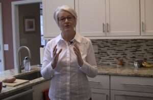 Cynthia Allen demonstrating 15 Exercises to Save Your Back Standing in the Kitchen